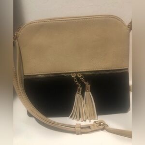 Lightweight med. crossbody shoulder bag with tassel and zipper in tan and black